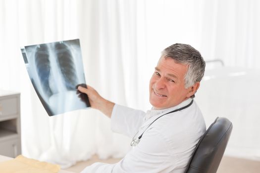 A senior doctor looking at the Xray