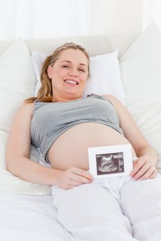 Delighted pregnant woman with her ultrasound