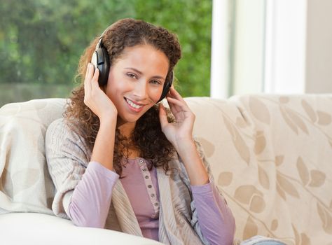 Radiant woman listening to music