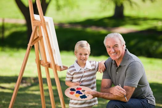 Grandfather and his grandson painting