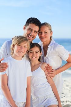 Portrait of a cute family at the beach