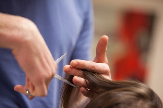 Close up of a masculine hand cutting hair