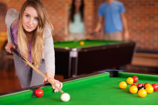 Cute woman playing snooker