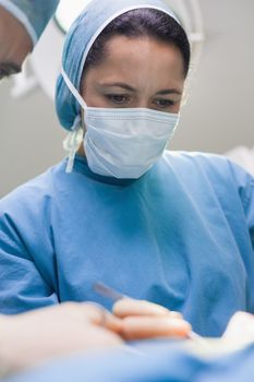 Doctor operating a patient