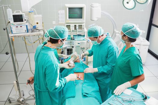Surgeons operating a patient in an operating theater