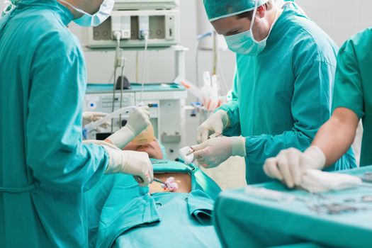 Surgeon operating a patient in an operating theater