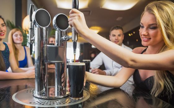 Attractive woman pulling a pint of stout