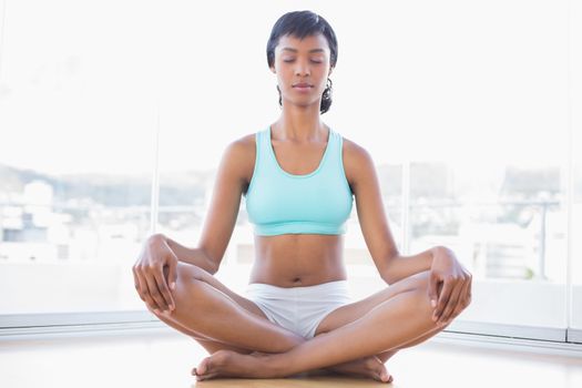 Meditative black haired woman doing yoga
