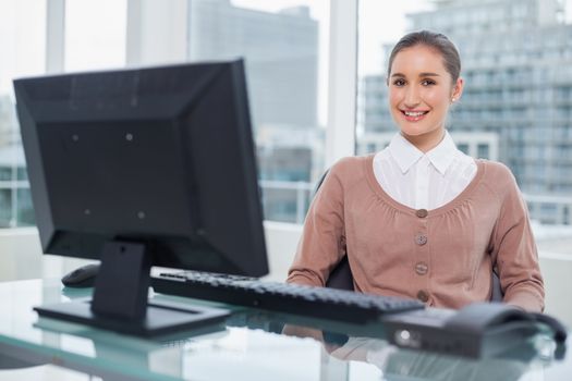 Smiling businesswoman sitting on swivel chair
