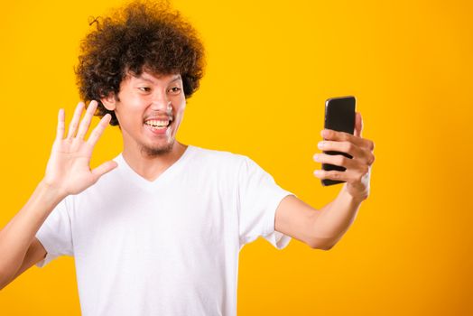 Portrait asian handsome man curly hair taking selfie with mobile