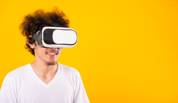 Asian handsome man with curly hair he using virtual reality head