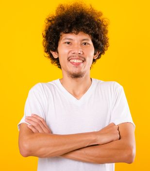 Portrait of Asian handsome man with curly hair with arms crossed