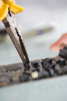 Close up of pliers repairing hardware