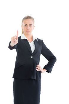 Concentrating young business woman pointing upwards