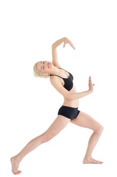Full length of a sporty young woman dancing