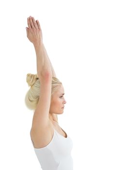 Toned woman with joined hands over head