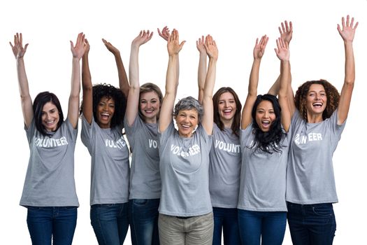 Portrait of happy volunteers standing with hands raised