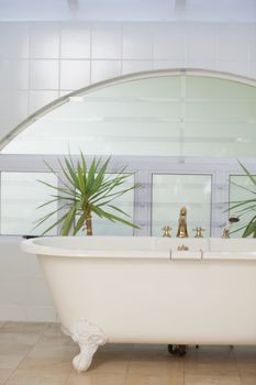 Contemporary bathroom interior with tub and tiled wall