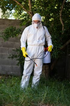 Man spraying pesticide on grass