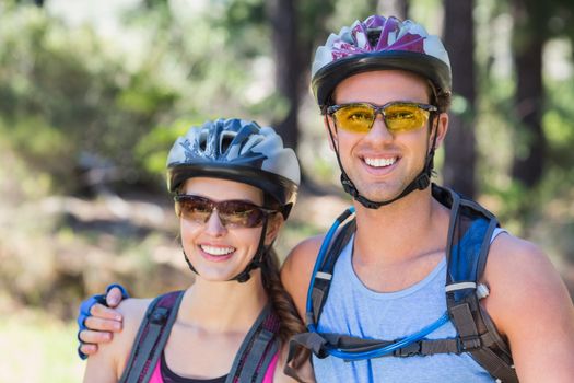 Portrait of young couple wearing helmets at forest
