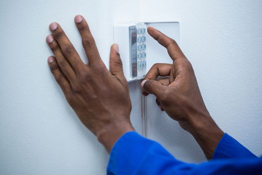 Hand touching home security keypad