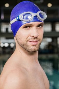Portrait of swimmer wearing swimming goggles and cap