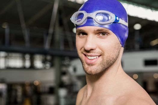 Portrait of swimmer wearing swimming goggles and cap