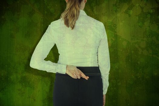 Composite image of rear view of businesswoman with fingers crossed over white background