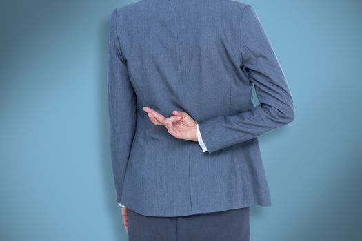 Composite image of businesswoman with fingers crossed behind her back