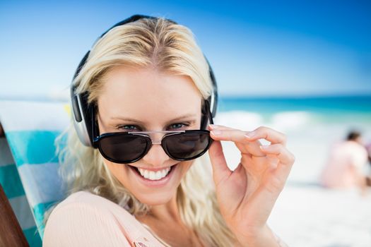  Woman listening to music through earphones 