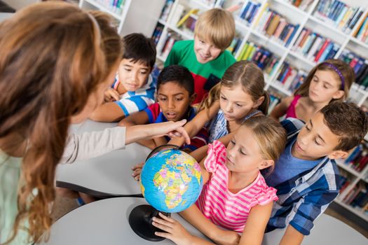 pupils looking at globe