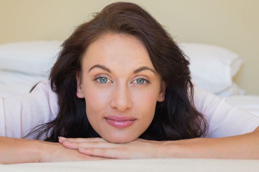 Close-up of beautiful woman lying in bed