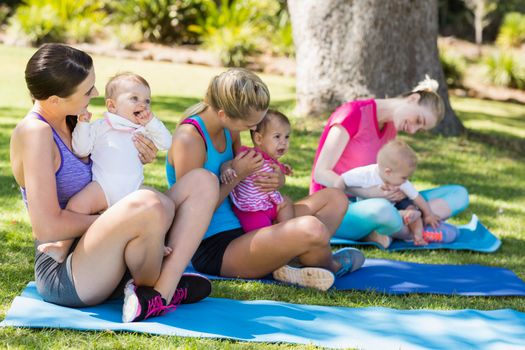 Women sitting with their babies in park