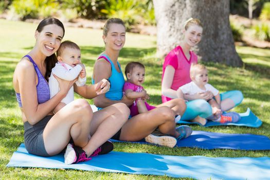 Women sitting with their babies in park