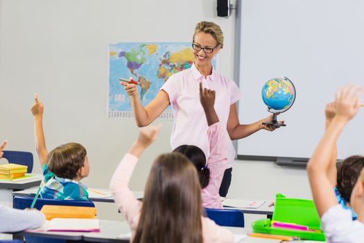 Teacher having lesson with a globe