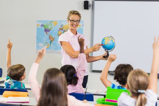 Teacher having lesson with a globe 