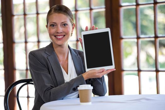 Woman presenting a tablet