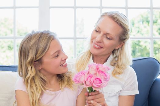 Girl giving flowers to mother