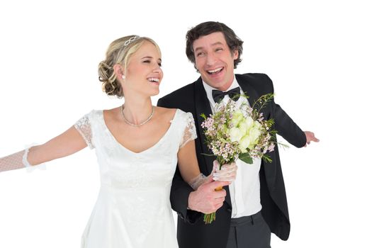 Happy newlywed couple holding bouquet