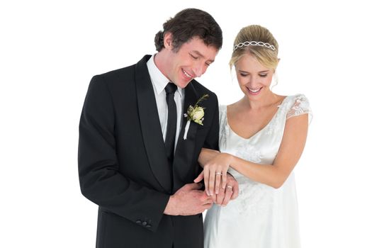 Newlywed couple looking at wedding rings