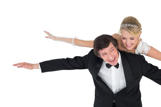 Playful newly wed couple with arms outstretched
