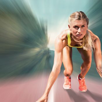 Composite image of sportswoman starting to sprint