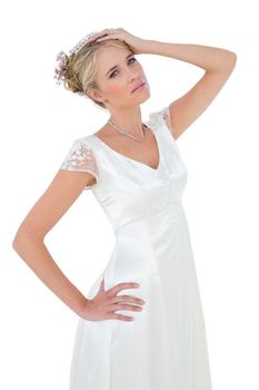 Sensuous bride posing against white background