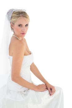 Sensuous bride in off shoulder dress against white background