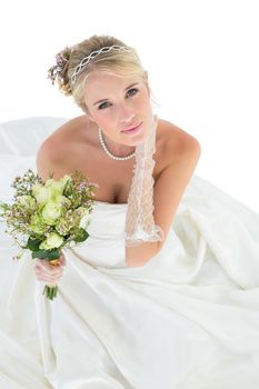Portrait of sensuous bride holding flower bouquet