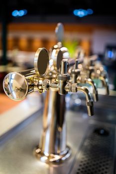 Close-up of beer pump in a row