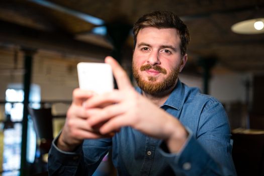 Man text messaging on mobile phone
