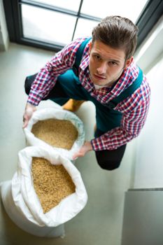 Brewer with sack of grains 