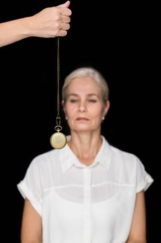 Cropped image of hypnotherapist holding pendulum before woman