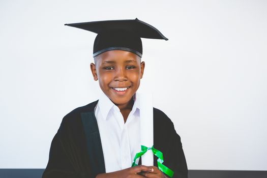 Portrait of schoolkid pretending to be graduate